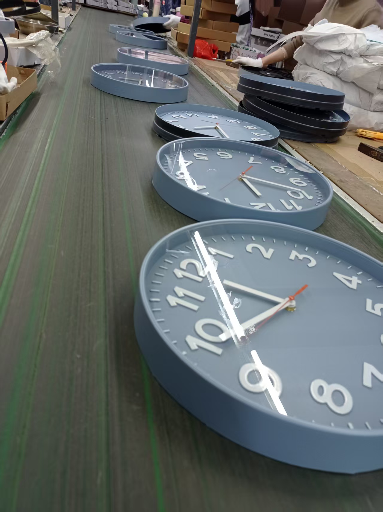 Assembly line for plastic wall clocks